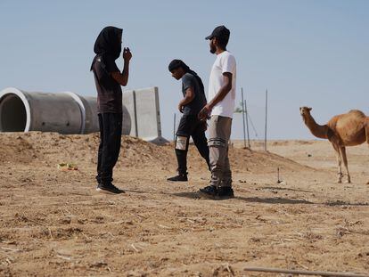 Vecinos de Al Bat, junto a un tubo de hormigón que hace las veces de refugio antiaéreo, instalado después de que un cohete de Hamás matara a cuatro niños el 7 de octubre.