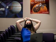 Engineer Sierra Gonzales watches a broadcast of the landing on Mars of NASA's Perseverance rover at Lockheed Martin Space's Waterton Campus in Littleton, Colo., on Thursday, Feb. 18, 2021. (Chancey Bush/The Gazette via AP)