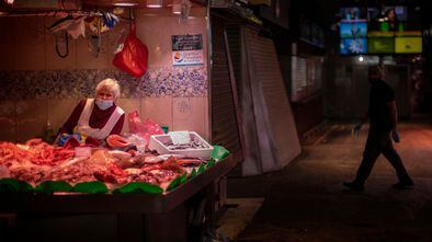 A fish monger waits for customers at her fish shop in Barcelona, Spain, Wednesday, April 29, 2020 as the lockdown to combat the spread of coronavirus continues. Official statistics show that Spain's unemployment rate rose to 14.4% in the first quarter of 2020, reflecting only the partial impact of the new coronavirus pandemic in Spain's job market. Spain's left-wing coalition government is poised to announce Tuesday further steps to ease the 7-week lockdown, one of the world's strictest. (AP Photo/Emilio Morenatti)