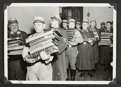 Nazis carry Jewish books, presumably to burn them, on the night of November 9-10 in the German city of Fürth. 