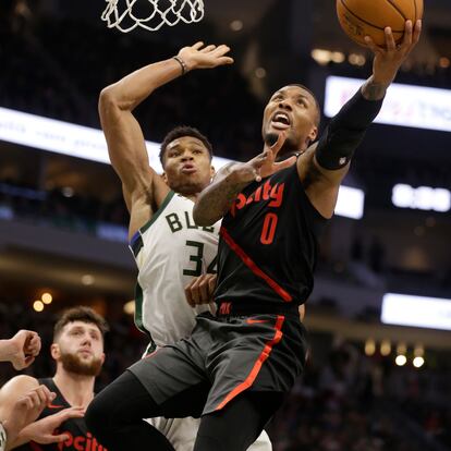 FILE - Portland Trail Blazers' Damian Lillard (0) drives against Milwaukee Bucks' Giannis Antetokounmpo (34) during the second half of an NBA basketball game Wednesday, Nov. 21, 2018, in Milwaukee. Damian Lillard is being traded by Portland to play alongside Antetokounmpo in Milwaukee, a person with knowledge of the agreement said Wednesday, Sept. 27, 2023, a move that ends a three-month saga surrounding his wish to be moved elsewhere with hopes of winning an NBA title and ending his 11-year run with the Trail Blazers. (AP Photo/Jeffrey Phelps, File)