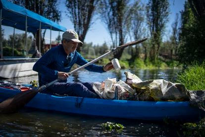 Menchaca collects garbage in his kayak through the channels of Xochimilco.