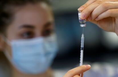 A health worker prepares a dose of the Pfizer-BioNTech vaccine against covid at a vaccination center in Ancenis-Saint-Gereon, France.