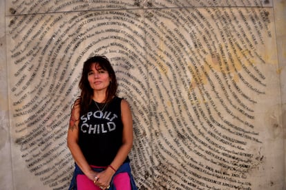María Belén Altamiranda in front of the fingerprint with the names of those who disappeared during the dictatorship. 