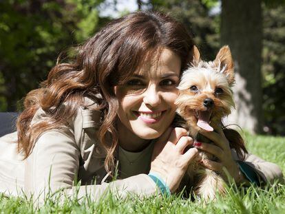 La actriz tumbada con su perro Rufus Júnior en el parque del Retiro, en Madrid,