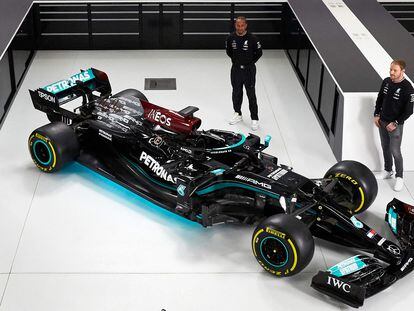 El piloto británico Lewis Hamilton (centro) y el finlandés Valtteri Bottas (izquierda) posan junto al Mercedes-AMG F1 W12 en el acto de presentación del nuevo monoplaza de 2021.