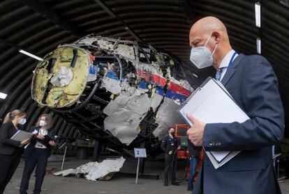El juez Hendrik Steenhuis y otros jueces y abogados ven los restos reconstruidos del vuelo MH17 de Malaysia Airlines, en la base aérea militar de Gilze-Rijen, en Países Bajos, en mayo de 2021.