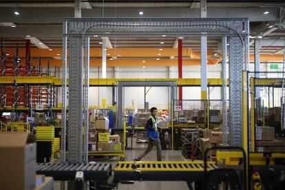 Amazon espera aumentar un 80% sus ventas con respecto a 2015 y superar el millón de productos vendidos en 24 horas. En la imagen, un trabajador de Amazon camina por una zona del almacén.