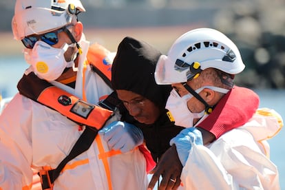 Dos trabajadores de Salvamento Marítimo ayudaban el día 2 de mayo a uno de los 60 inmigrantes localizados en un cayuco a 22 kilómetros de Arguineguín (Gran Canaria).