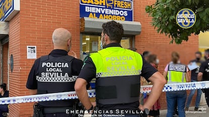 Varios agentes de la policía en las inmediaciones del supermercado de Sevilla en el que ha sido abatido un atracador este viernes por la tarde.