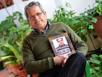 Guillem Agull&oacute; Sr holds a photograph of his son.