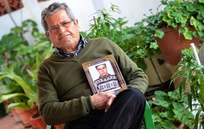 Guillem Agulló Sr holds a photograph of his son.