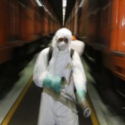 Un operario desinfecta unos trenes en México para evitar la propagación de la gripe A