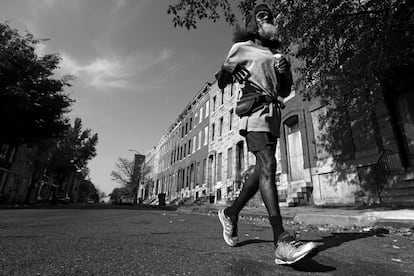 BALTIMORE, MD - NOVEMBER 02: Keith Boissiere runs on Harlem Avenue on November 2, 2016 in Baltimore, Maryland. After being attacked in November 2014, and to help avoid those types of circumstances, Boissiere says that's the reason he only navigates the city in broad daylight. The aging 'Running Man' is still accumulating the miles almost daily. While he no longer has a daily streak because of his ailing health, he takes to the streets whenever he is able.Keith Boissiere has been running nearly every day for the past three decades - averaging more than 20 miles per day - for his health. Many residents only know the enigmatic figure by his nickname of the 'Running Man' - but Boissiere, 64, is a green-card-carrying Trinidad and Tobago native living in solitude on the border of Harlem Park and Sandtown-Winchester: two menacing neighborhoods in Baltimore City. Having never competed, nor having a desire to do so, the 'Running Man' held a daily streak of 12 and a half years which helped him earn his alias. But his health took a turn for the worse in 2008 - the streak ended - as his life almost did, too. Through all of his troubles, which includes being on a kidney donor recipient list, Boissiere copes the only way he knows how - he continues to run - as the hospital encouraged him to do in order to aid his failing health. He doesn't brag about his accomplishments or mention his celebrity-like status despite being constantly acknowledged - and these days barriers such as rain, snow and hospital appointments often dictate his running schedule. His drive and passion for his own health is often described as bringing positivity and strength to residents in the city, and the people of Baltimore still witness the 'Running Man' from West to East, and North to South, as he competes with only himself to stay upright by staying fit in a city plagued by: drugs, guns, crime, and violence.   Patrick Smith/Getty Images/AFP
== FOR NEWSPAPERS, INTERNET, TELCOS & TELEVISION USE ONLY ==