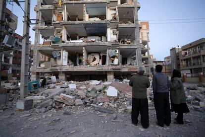 Las poblaciones más afectadas por el terremoto son Kermanshah, Ghasr Shirin, Sarpul y Azgale, donde las comunicaciones telefónicas y la luz quedaron anoche cortadas. En la imagen, residentes miran los destrozos causados en un edificio de viviendas en la ciudad iraní de Sarpol-e-Zahac.