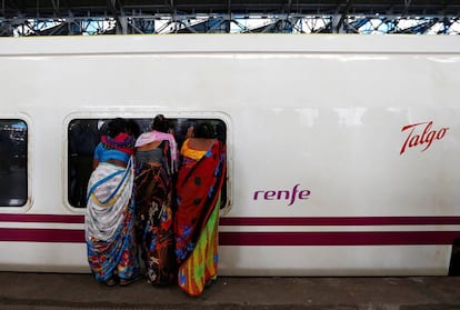 Women peeking inside a Talgo train in Mumbai.