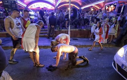 A drunk tourist falls to the floor in Punta Ballena, Magaluf in the early hours of a Saturday morning.