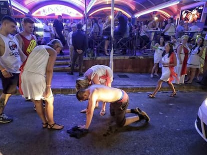 A drunk tourist falls to the floor in Punta Ballena, Magaluf in the early hours of a Saturday morning.