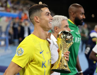 Al Nassr's Cristiano Ronaldo celebrates with the trophy after winning the Arab Club Champions Cup final