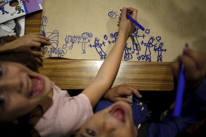 Crianças sorriem enquanto fazem desenhos infantis em Puente Tocinos em Murcia (Espanha), em 3 de novembro de 2015.