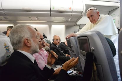 The pope speaks to reporters on his plane Monday while returning to Rome.