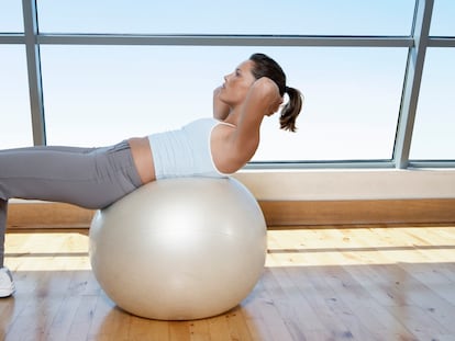 A woman does crunches.