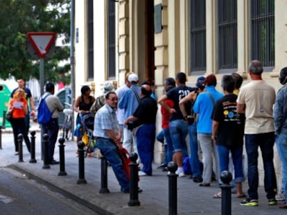 Los usuarios del comedor de Casa Caridad en Valencia, este martes, esperan para entrar a comer.