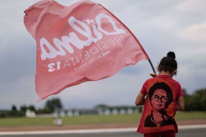 Partidária de Dilma Rousseff segura uma bandeira diante o Palácio da Alvorada em Brasília.