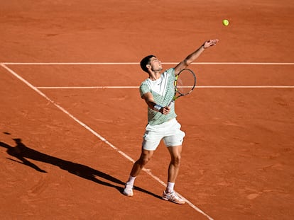 Carlos Alcaraz serves during a match on court Philippe Chatrier at Roland Garros.