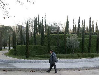 Un vigilante pasa delante del Bosque de los Ausentes, el jardín del parque del Retiro que recuerda a las 191 víctimas.