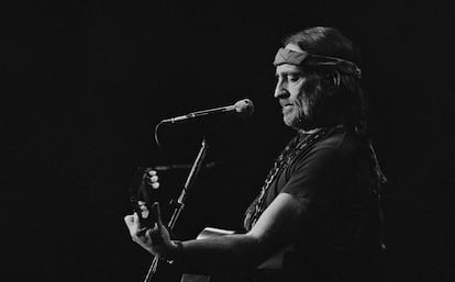 Willie Nelson plays guitar during a concert, in an undated image.