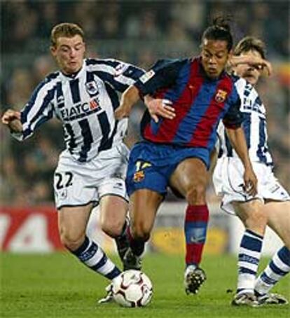 Ronaldinho disputa el balón con Potillón, de la Real Sociedad.