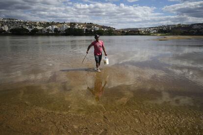 Un hombre camina por el lecho del r&iacute;o Doce.