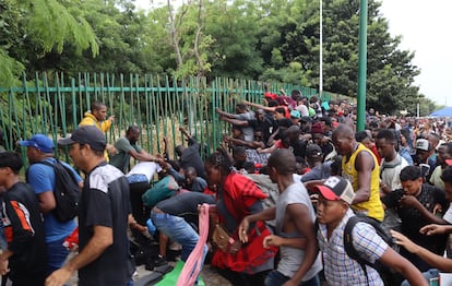 Grupos de migrantes rompen el cerco de seguridad para exigir papeles migratorios, en Tapachula, estado de Chiapas (México).