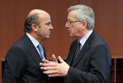 El ministro de Econom&iacute;a, Luis de Guindos, escucha al presidente del Eurogrupo, Jean-Claude Juncker