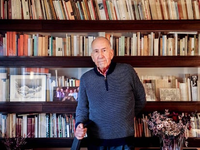 Joan Margarit, en su casa de Barcelona, con sus libros y algunos dibujos y fotografías suyas entre las baldas.