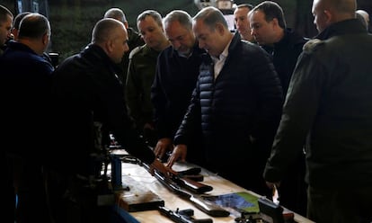 El primer ministro israel&iacute;, Benjam&iacute;n Netanyahu (c), observa una muestra de armas confiscadas en Cisjordania, este martes. 