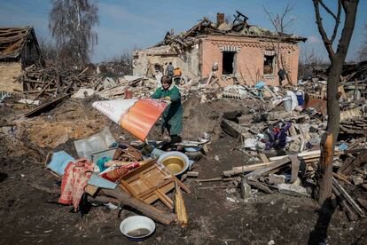 Halyna, a local resident, throws stuff near her house, destroyed during a Russian missile strike, amid Russia's attack on Ukraine, near Kyiv, Ukraine March 21, 2024