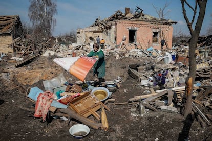 Halyna, a local resident, throws stuff near her house, destroyed during a Russian missile strike, amid Russia's attack on Ukraine, near Kyiv, Ukraine March 21, 2024