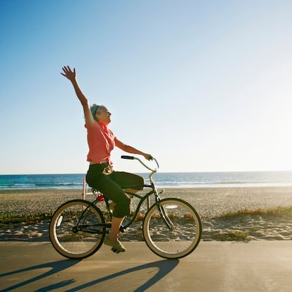 Caucasian woman riding bicycle near beach