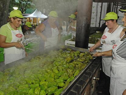 Varias mujeres cocinan durante la preparación de la fiesta del pimiento de Arnoia, en Ourense.