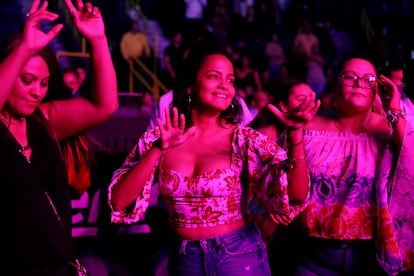 Monica Vaca, left, Ana Mendieta, and Carla Teran, all of Naples, Florida, originally of Bolivia, dance to the music of the cumbia group Los Ángeles Azules during their 40 Years anniversary tour at the Hertz Arena on Sunday, Nov. 7, 2021 in Estero, FL. Super cumbia group Los Ángeles Azules, of Iztapalapa, a borough of the Federal District of Mexico City, celebrates their 40th anniversary as a band touring the USA.