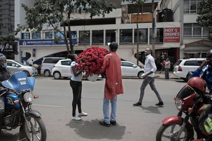 Vendedores de flores entregan un gran ramo de rosas en una calle durante las festividades del día de San Valentín en Nairobi (Kenia).