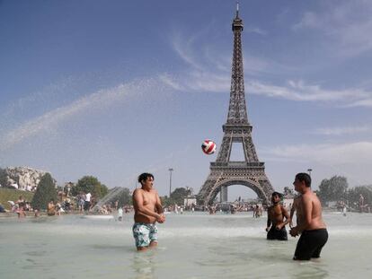 Jóvenes junto a la Torre Eiffel durante la ola de calor de la semana pasada.