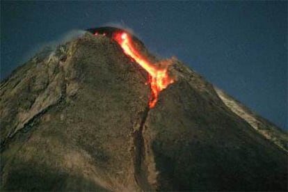 El volcán, escupiendo lenguas de lava.