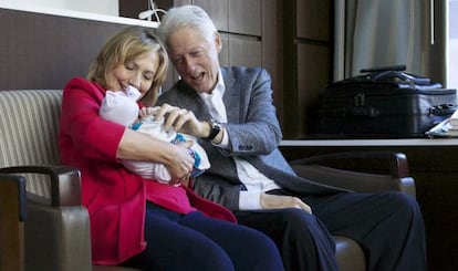 Hillary y Bill Clinton sujetan a su nieta Charlotte el d&iacute;a de su nacimiento.