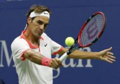 Federer of Switzerland returns a backhand to Djokovic of Serbia during their men's singles final match at the U.S. Open Championships tennis tournament in New York