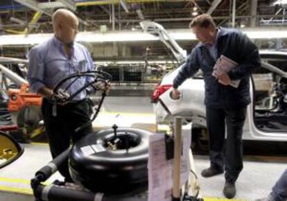 Técnicos de la factoría de General Motors en Figueruelas (Zaragoza), explican el montaje del depósito de los nuevos coches GLP. EFE/Archivo