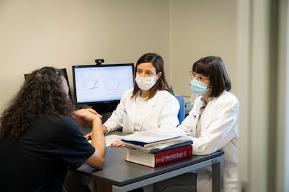 Hematologist Julia Montoro and geneticist Sara Torres Esquius attend to one of their patients, César Martínez, in a consultation room at Vall d'Hebron. 