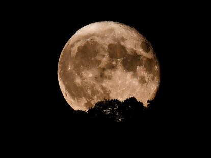 La luna sale por encima de una colina, el 2 de agosto de 2023.